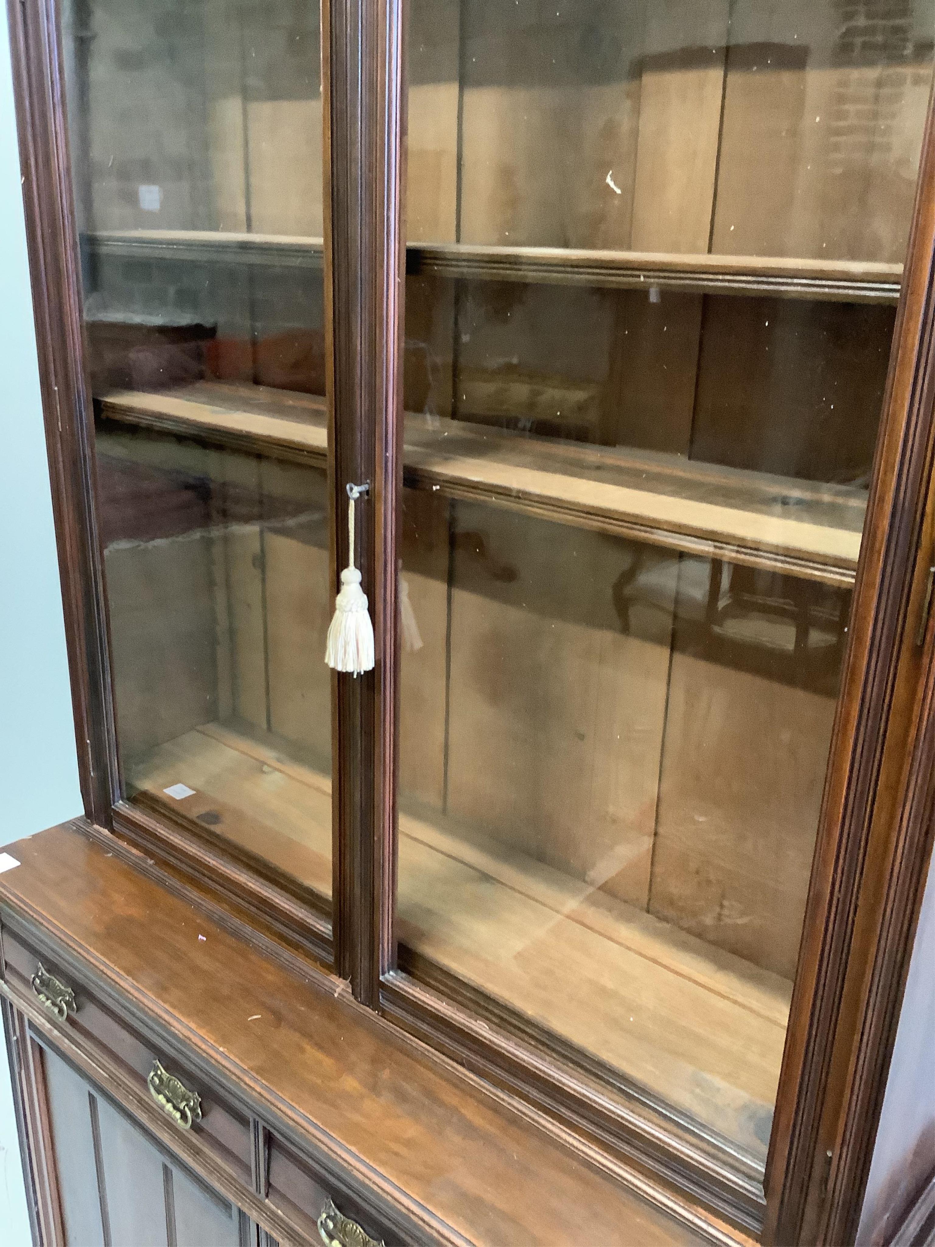 A late Victorian mahogany bookcase cabinet, width 122cm, depth 43cm, height 225cm. Condition - fair